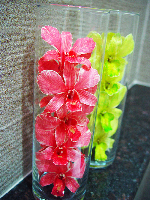 Red and Green Dried Orchid Head in a Glass Bottle- Prosco